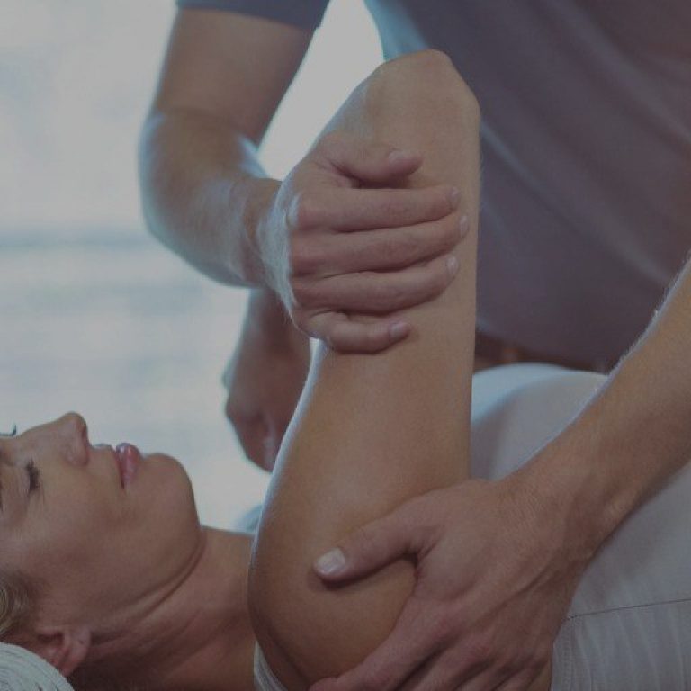 Woman Receiving Shoulder Therapy From Physiotherapist Picture Id613759142